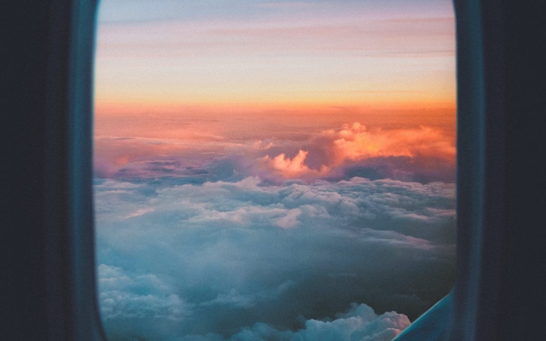 plane window overlooking sea of clouds