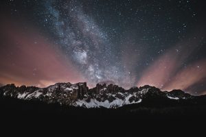 snow covered mountain under starry night